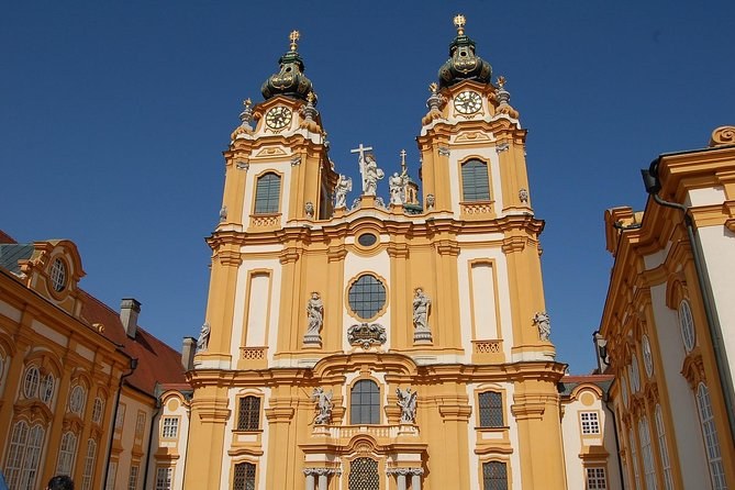 The twin towers and facade of the abbey church above the courtyard