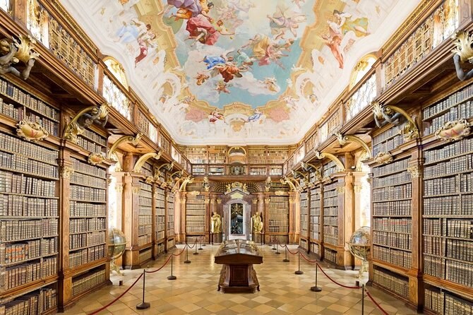 The main room of the abbey library, gilded bookcases under a painted ceiling
